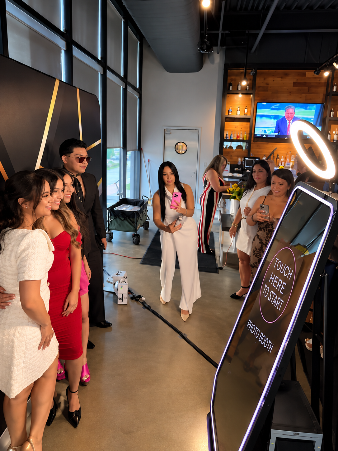 Guests using the Magic Mirror Photo Booth touchscreen at an event
