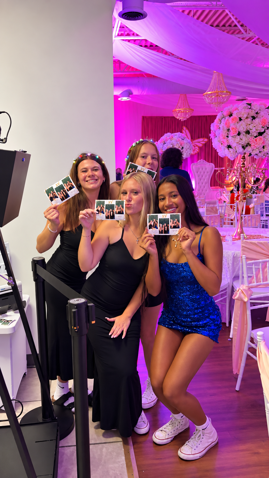 Guests holding printed photo strips at an Atlanta event